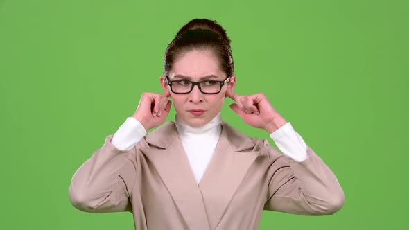 Girl Closes Her Ears From a Sharp Noise. Green Screen. Slow Motion alt