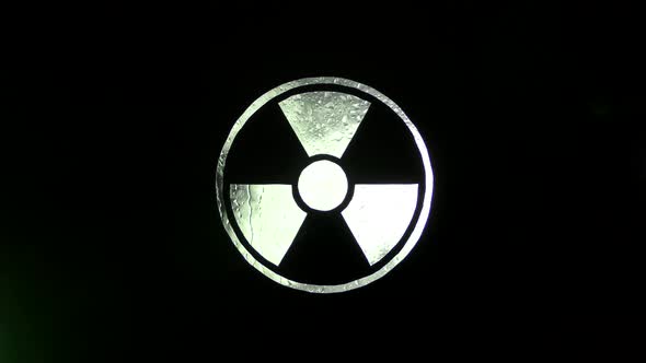 Radiation hazard sign with acid drops and smoke.