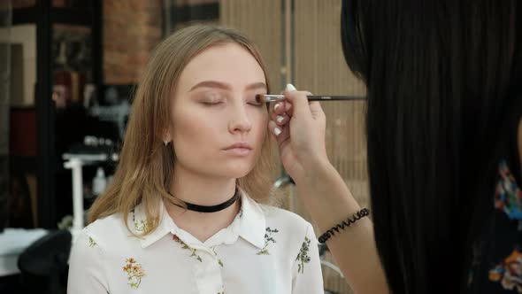 the Make-Up Stylist Doing a Make-Up to Hipster Model alt