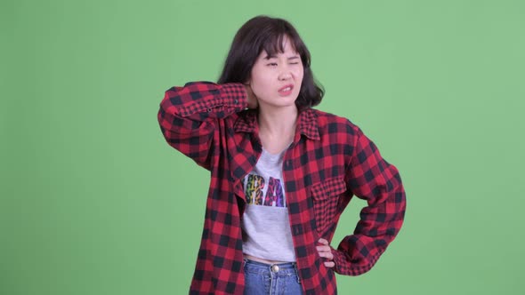 Stressed Asian Hipster Woman Having Neck Pain alt