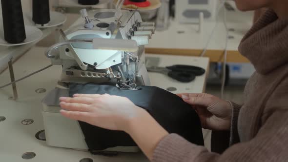 Sewing workshop. Processing the edge of the product on the overlock. Zigzag machine stitch alt