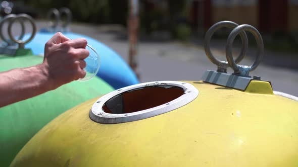 Man putting plastic, disposable mug into recycling bin alt