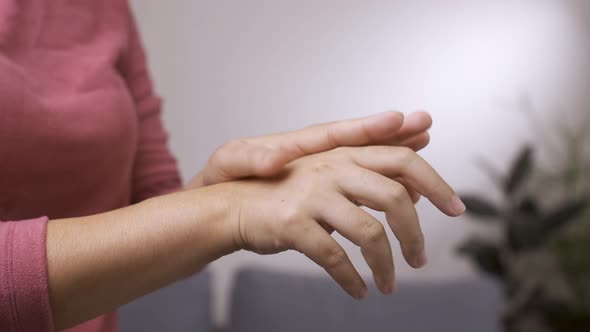 Woman sanitizing hands with alcohol spray for preventing COVID-19. New normal concept. alt