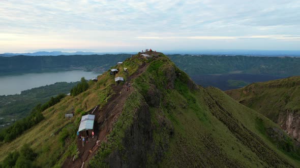 aerial over a green ridge at Mount Batur Volcano crater during sunrise in Bali Indonesia alt