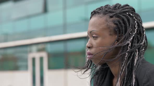 Thoughtful sad young black african business woman alone in the city alt