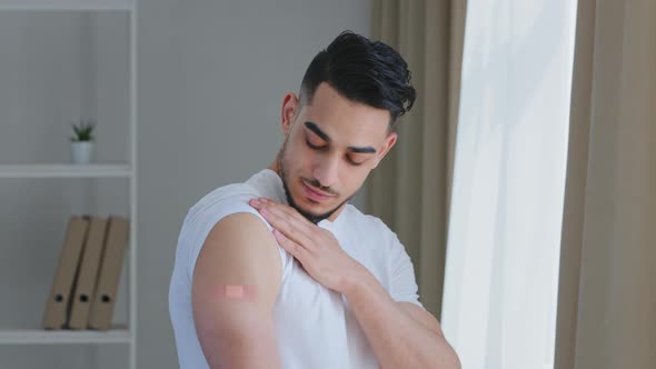Portrait of Arabic Ethnic Hispanic Man Guy Patient Shows Medical Plaster on Shoulder Demonstrates alt