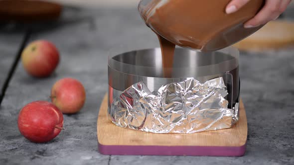 Woman Pastry Chef Pouring Chocolate Mousse Into Pastry Metal Ring