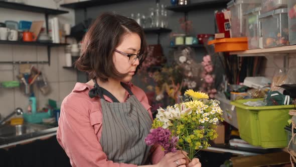 Young Woman Is Creating Romantic Bouquet in Work Process at Light Workshop.