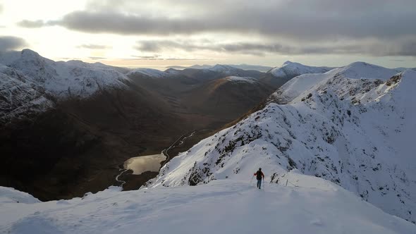 Aerial Reveal of a Mountain Climber on a Deserted Mountain Side alt