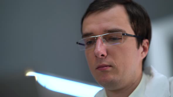 Doctor Working In Gray Room alt