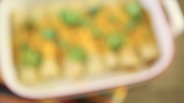 Chicken enchiladas with cheddar cheese and sauce. alt