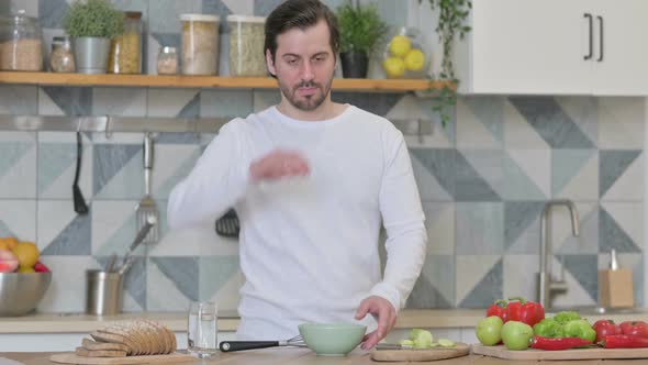 Healthy Young Man Feeling Tired While Cooking in Kitchen alt