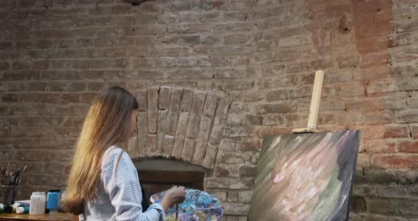 Talented Innovative Pretty Female Artist Draws with Brush on the Canvas. Contemporary Young Woman alt