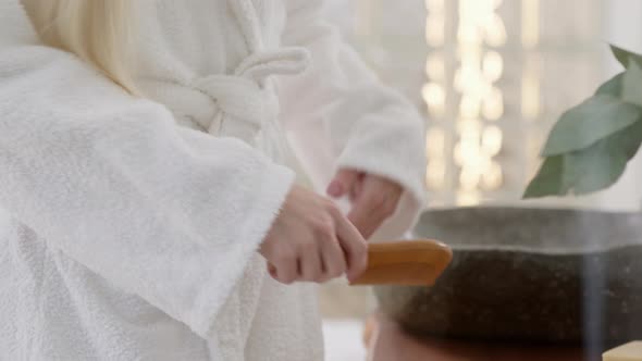 Close Up of Young Caucasian Woman With Long Blond Hair Wearing a Bath Towel Looking in the Mirror alt