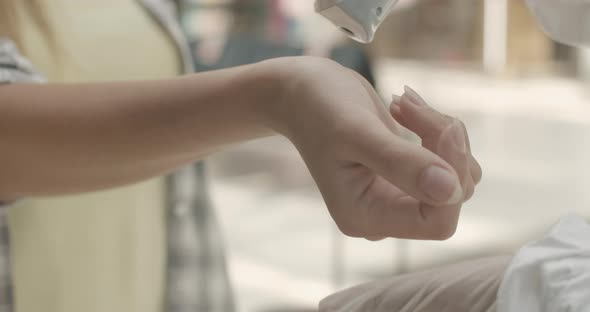 Close-up of Contactless Temperature Measurement on Covid-19 Pandemic. Unrecognizable Employee alt