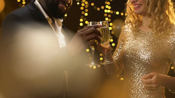 Happy Mixed-Race Couple Clinking Champagne Glasses Party, New Year Celebration alt
