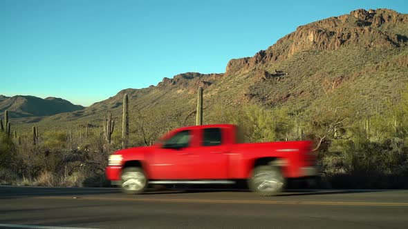 Tucson Mountain Park. Tucson, Arizona. Cars drive past in the foreground, on Gates Pass Road. alt