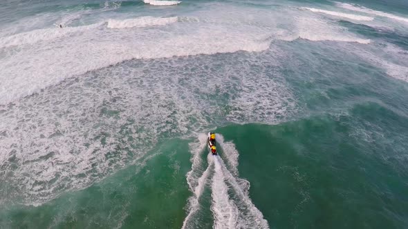 Aerial view of lifeguard surf rescue jet ski personal watercraft in Hawaii alt
