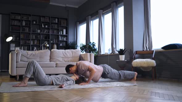 Couple Doing Morning Exercise in Home Interior
