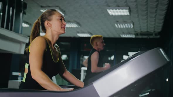 Fit Athletic Woman Running on the Treadmill Doing Her Fitness Exercise