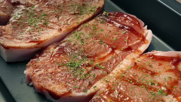 Seasoning Added To Pork Chops With Sauce And Tray Taken alt