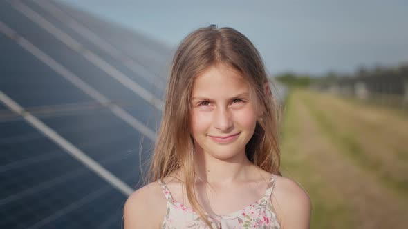 Portrait of a Little Girl Against the Background of a Solar Power Plant Yakana alt