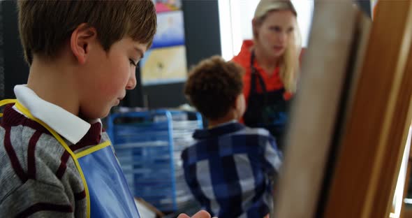 Attentive schoolboy panting on canvas alt