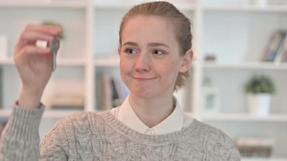 Portrait of Successful Young Woman Holding Key  alt