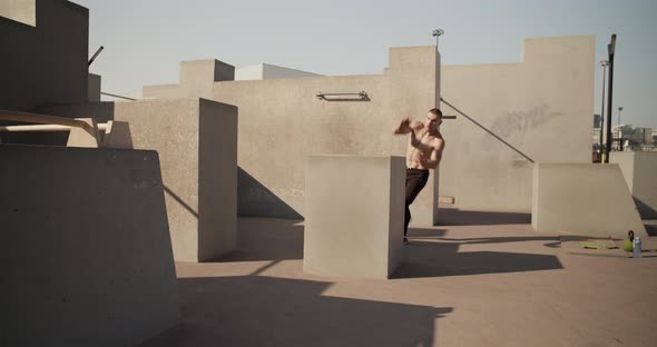 Male Athlete Leaping Over Barrier alt