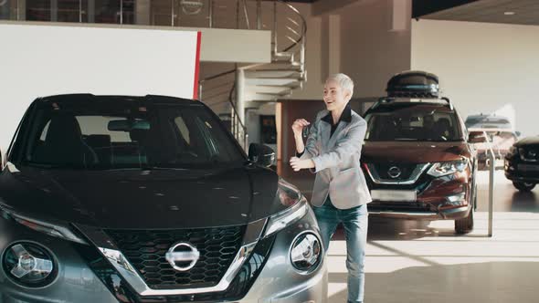 Adult Blond Woman Receiving Keys of Her New Car Photo of Laughing Caucasian alt