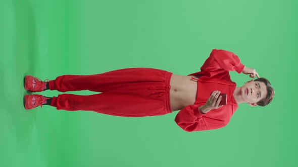 Full Body Of Young Transgender Male Use Mobile Phone And Thinking About Something On Green Screen alt