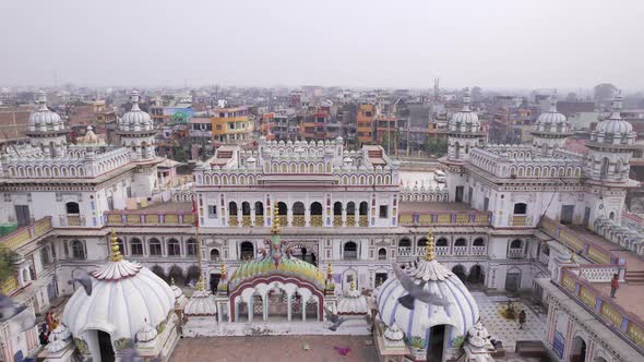 Aerial view over the city of Janakpur as a flock of pigeons fly by Janaki Temple alt