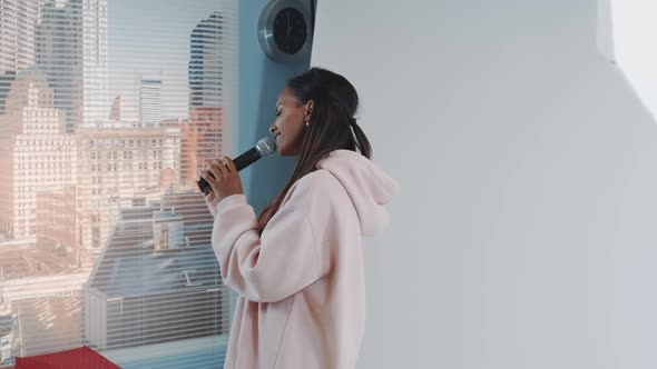 Closeup of Attractive Multiethnic Woman Posing with Microphone on Photo Shoot alt