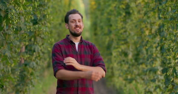A Portrait of a Farmer Folding His Arms While Standing in the Hop Field alt