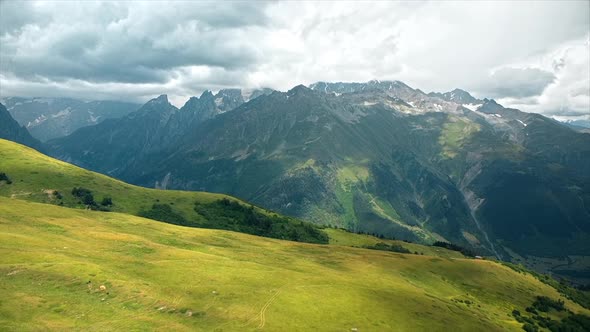 Aerial drone view of nature in Georgia. Caucasus Mountains, greenery, valleys, lush clouds alt