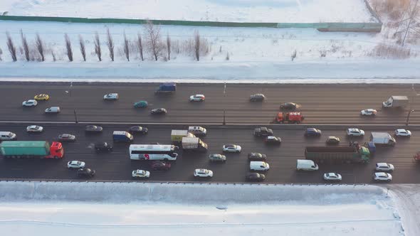 Traffic Jam on the Highway in Winter on a Bright Sunny Day