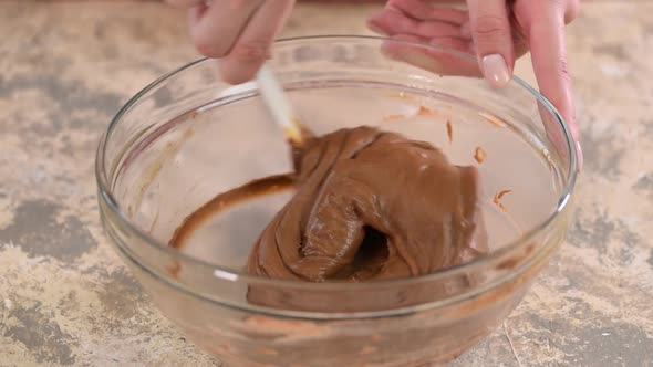 Mixing ingredients to make chocolate choux pastry at home alt