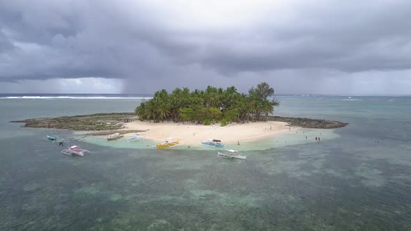 Aerial forward tracking pedestal up shot of Guyam Island, Siargao, the Philippines alt