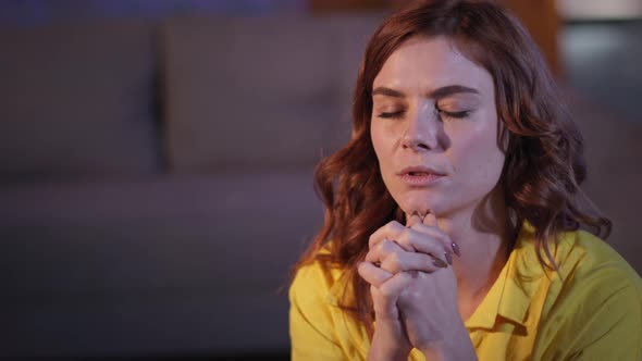 Woman with Folded Hands Prayer with Hope and Love in Her Heart to God Before Going to Bed in Room alt