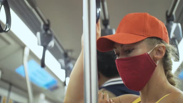 Woman Travel Caucasian Ride at Overground Train Airtrain with Wearing Protective Medical Mask alt