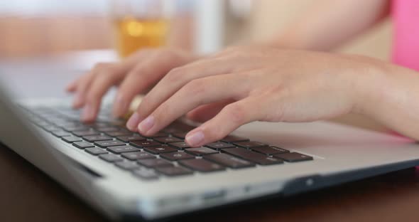 Woman type on computer at home alt