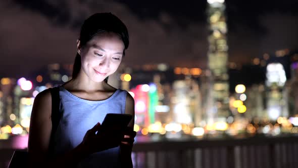 Woman using mobile phone in city  alt