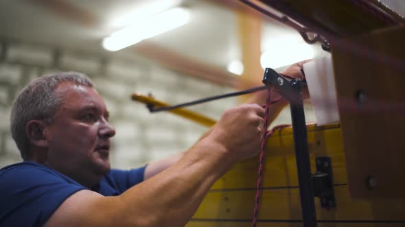 Master Work with Wooden Homemade Boat in Workshop alt
