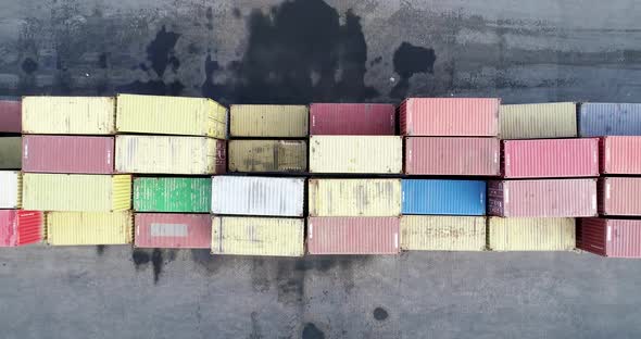 Top down view of colorful containers piles and truck in port container terminal, alt