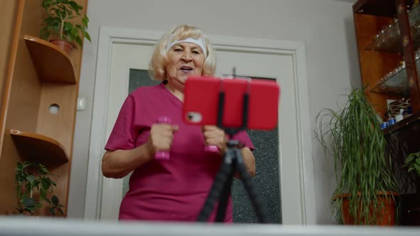 Old Senior Grandmother Woman Doing Workout with Dumbbells Running Fitness Sport Activity at Home alt