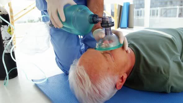 Male paramedic during cardiopulmonary resuscitation alt