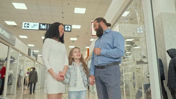 Mature Couple and Their Cute Daughter Enjoying Shopping Spree at the Mall alt