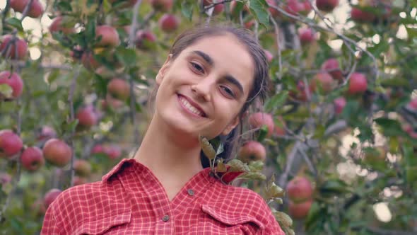 Portrait of a woman in the apple garden. Gardener