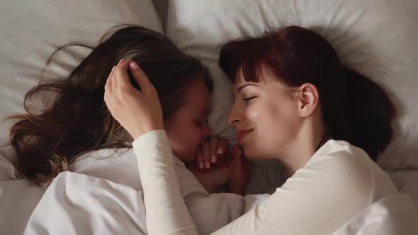 Close Up Top View of Calm Little Preschool Baby Girl Lying on Pillow Face to Face alt