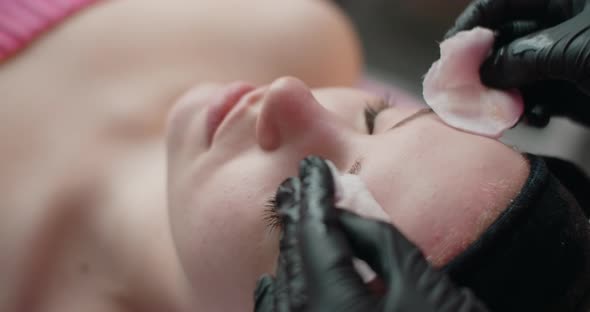 Beautician Wipes a Woman's Face with Sponges Face Care at the Beauty Salon  60p Prores HQ alt